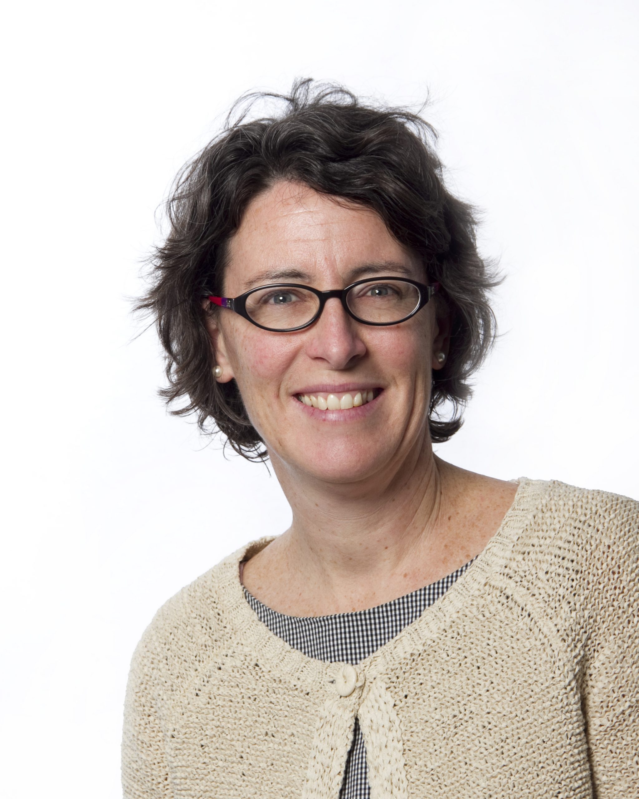 Close-up of smiling woman wearing glasses.