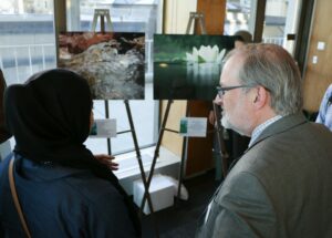 Hurley discusses two photography pieces with a student photographer